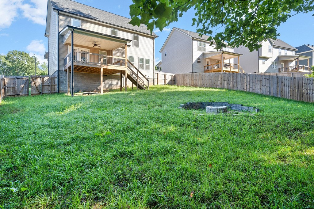 the back yard of a house with a fire hydrant in the grass