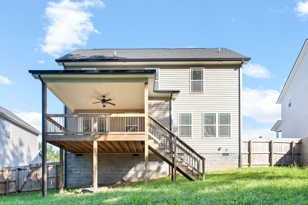 the back of a house with a deck and a staircase