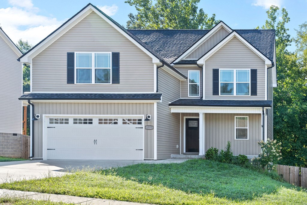 a house with a garage door in front of it