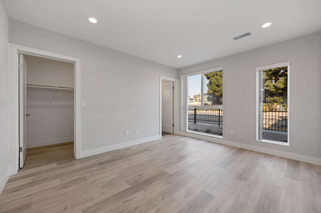 a living room with white walls and a sliding glass door