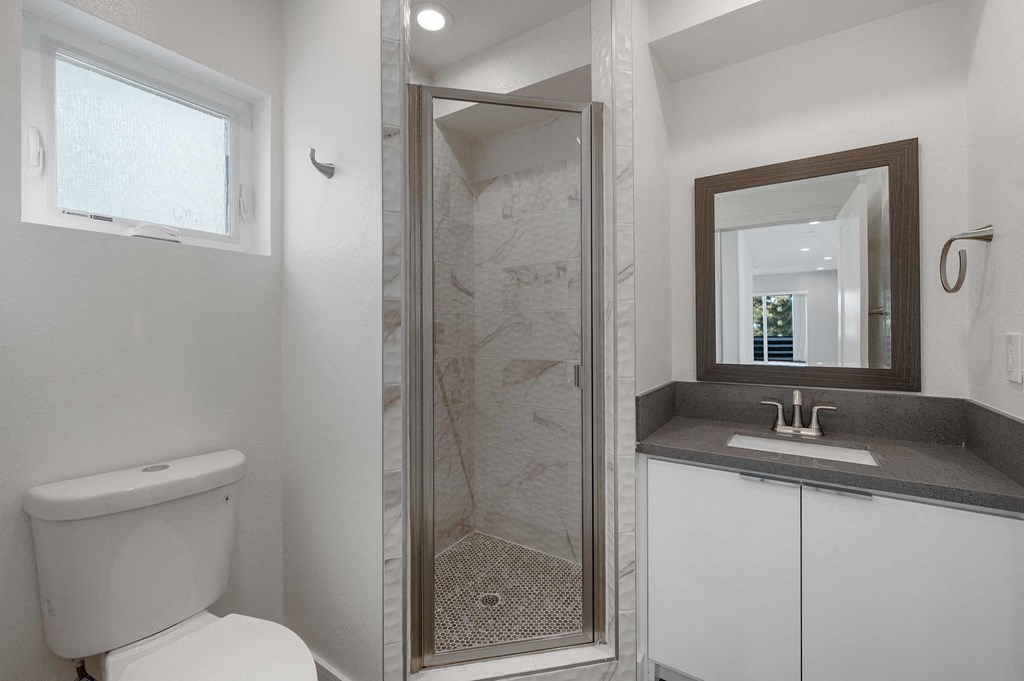 a small bathroom with a shower and a sink