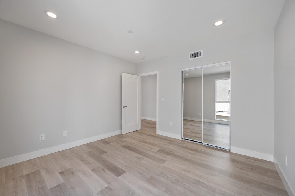 a living room with white walls and a sliding glass door