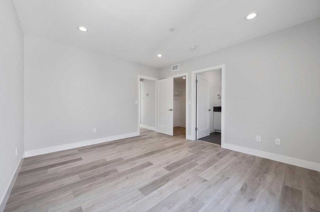a living room with white walls and wood flooring
