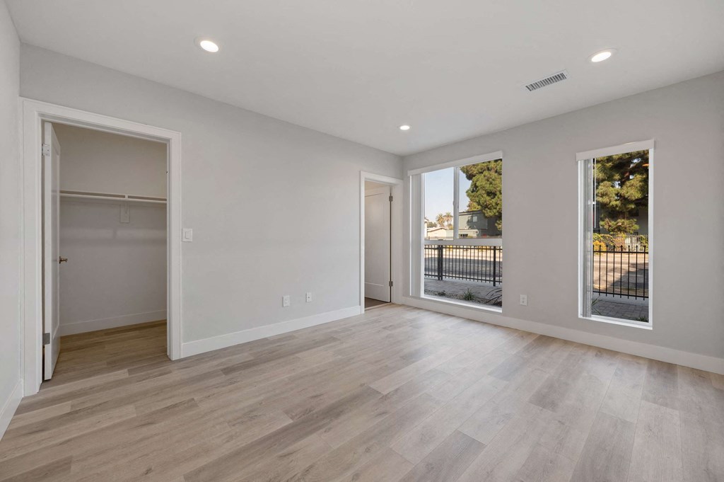 a living room with white walls and a sliding glass door