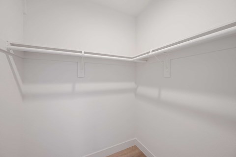 an empty room with white walls and a white closet