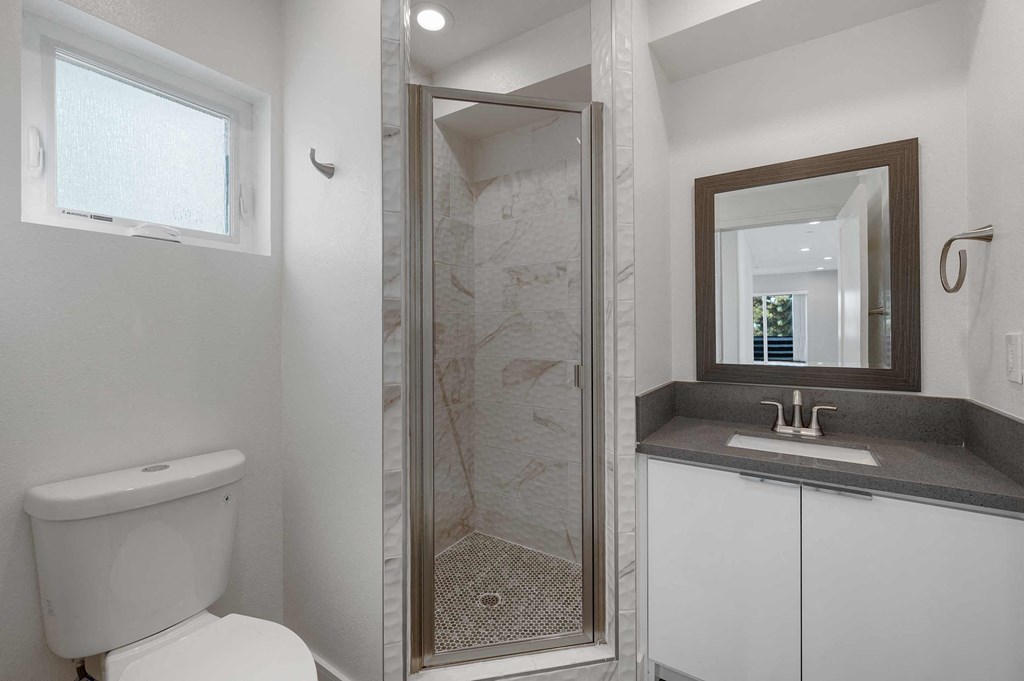 a small bathroom with a shower and a sink