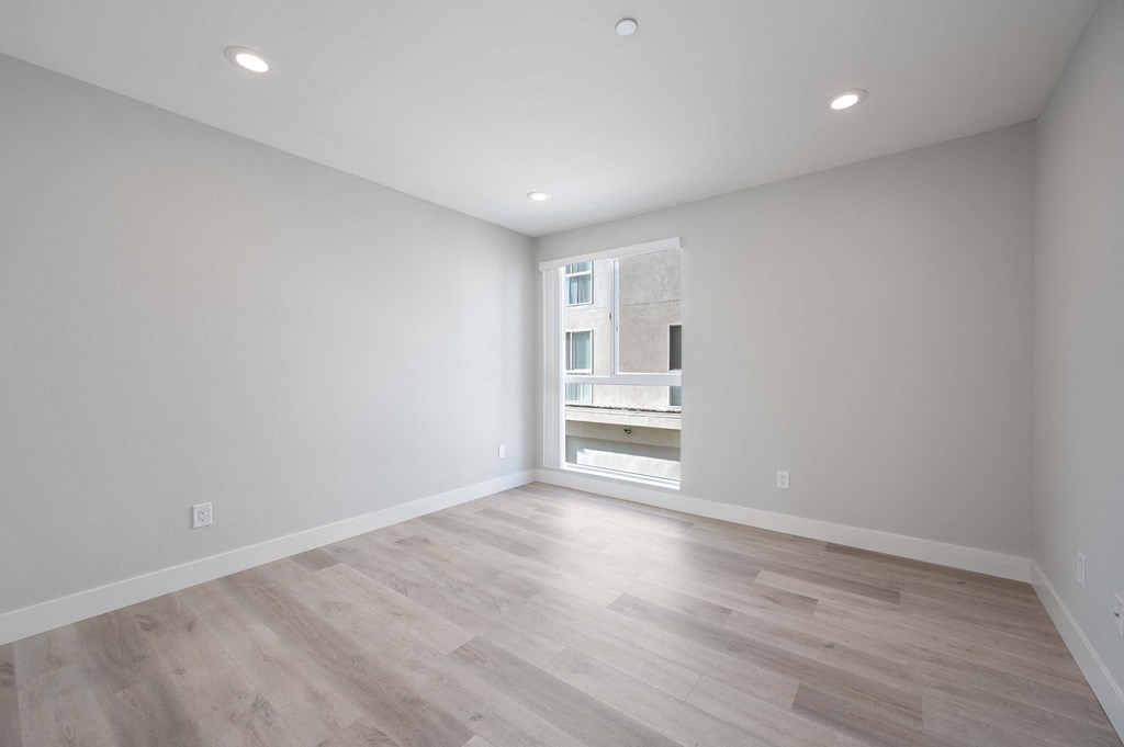 a living room with white walls and a window