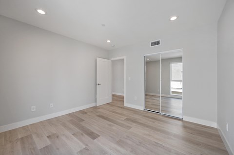 a living room with white walls and a sliding glass door