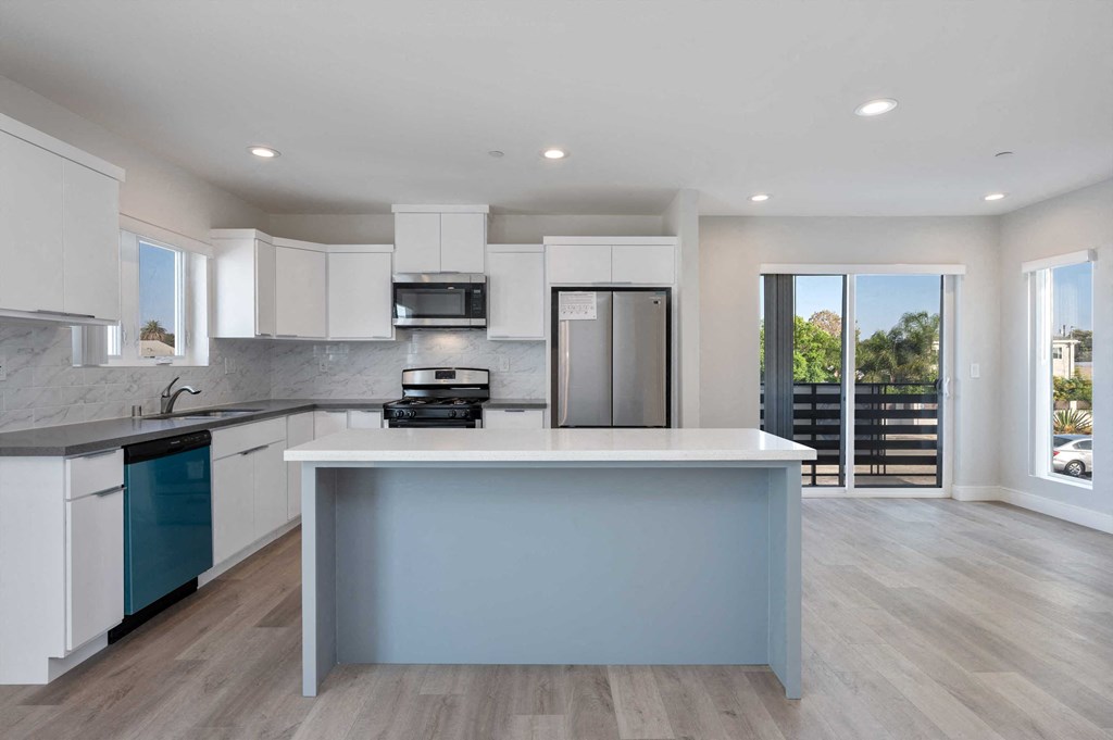 a kitchen with a large island in the middle