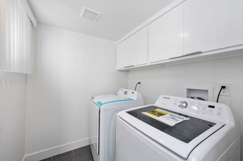 a laundry room with a washer and dryer in it