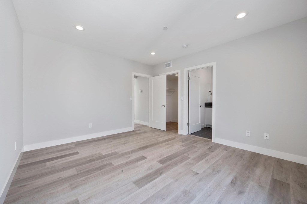 a living room with white walls and wood flooring