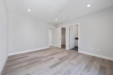 a living room with white walls and wood flooring