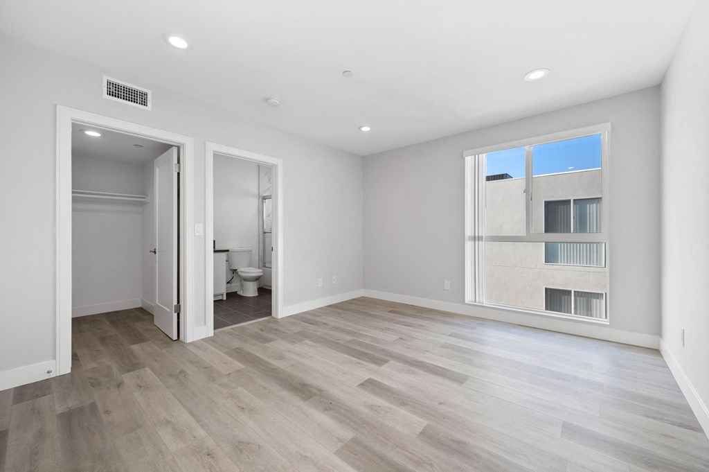 a living room with a large window and a door to a bathroom
