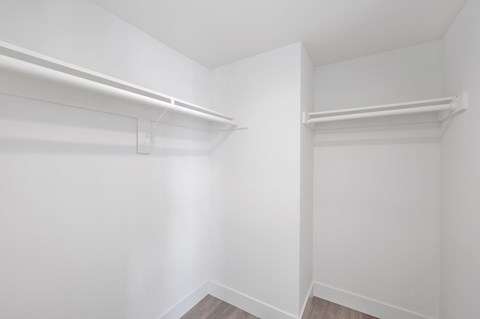 an empty room with white walls and a white closet
