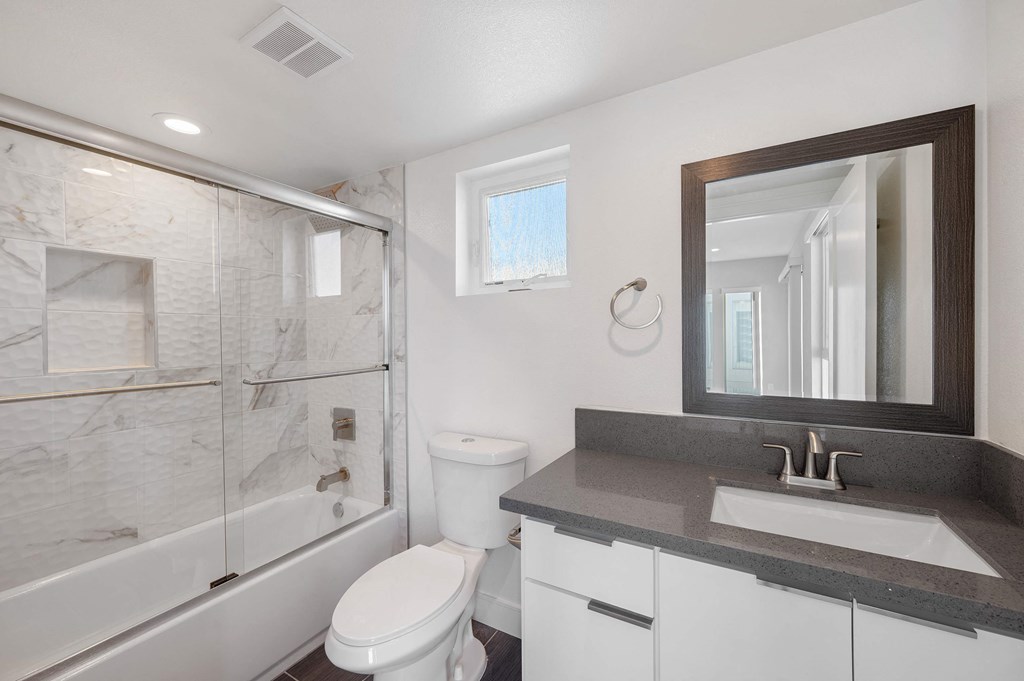 a bathroom with a sink toilet and a shower