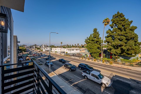 a view of a busy city street from a balcony