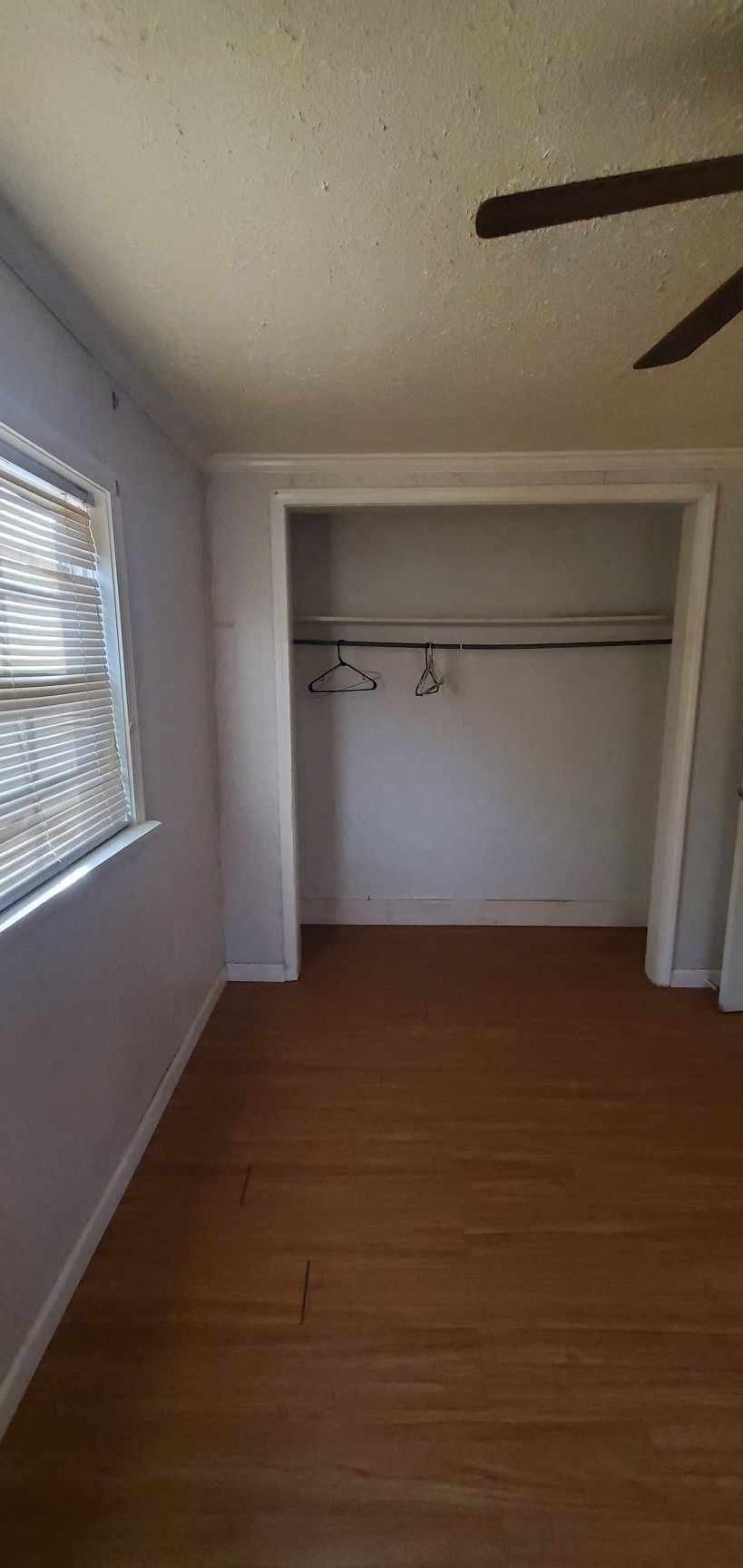 an empty room with a wooden floor and a window