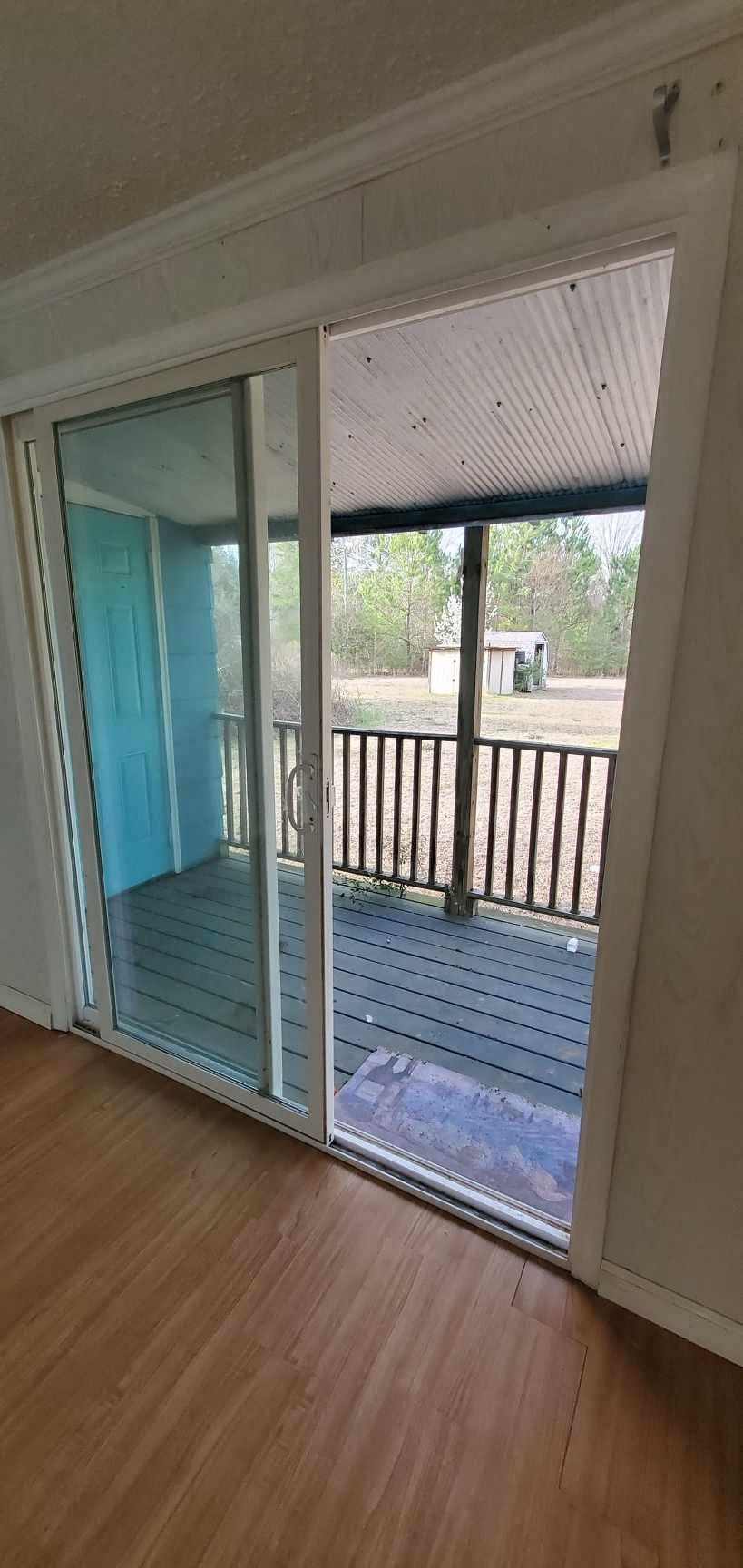 a view of a balcony from a room with sliding glass doors