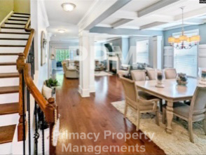a large dining room and living room with a table and chairs
