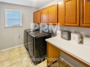 a kitchen with a dishwasher and wooden cabinets