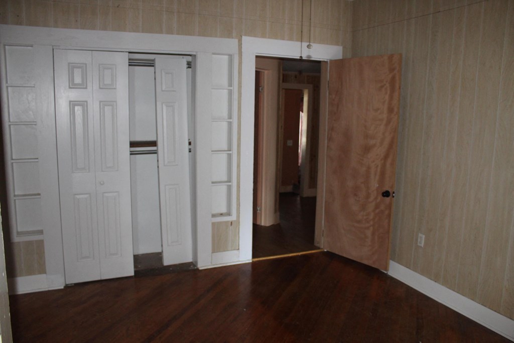 A room with a white door and a brown door.