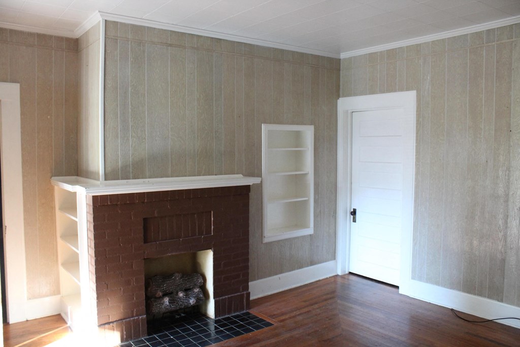 A room with a fireplace and a door.