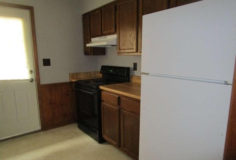 a kitchen with a stove and a refrigerator