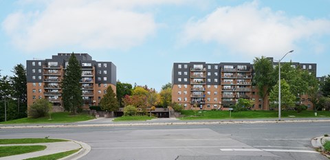 Two apartment buildings are situated next to each other.