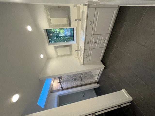 a small bathroom with a tv on the wall