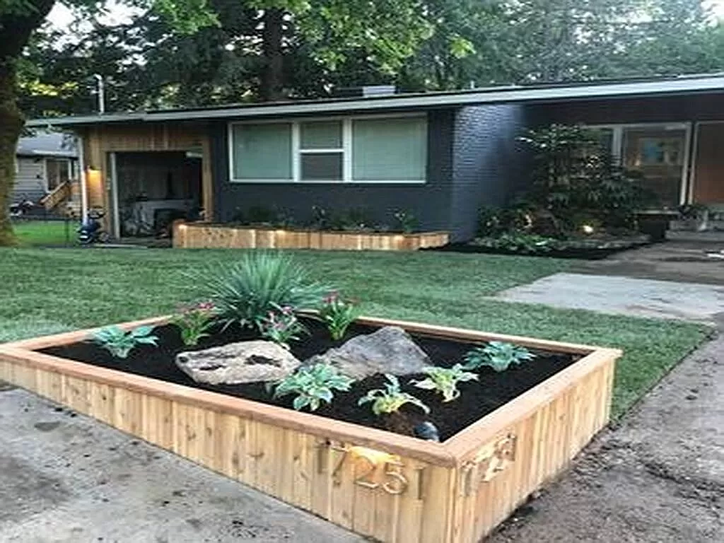a raised garden in a yard in front of a house