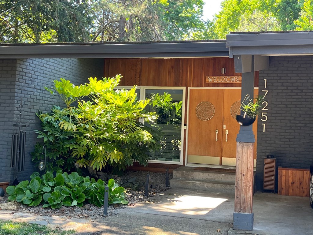 a building with a door and a sign on the side of it