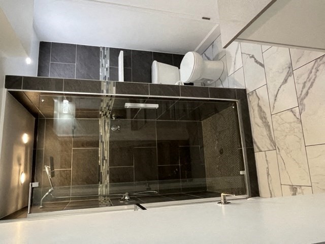 a bathroom with a large mirror and a shower