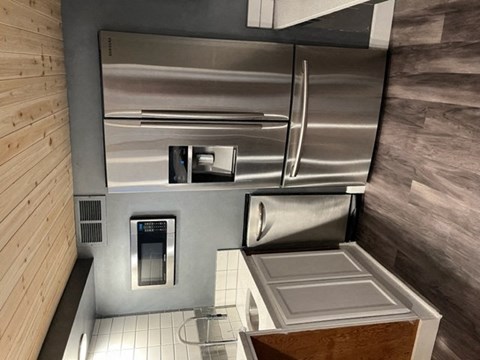 an overhead view of a kitchen with a stainless steel refrigerator
