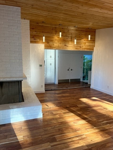 an empty living room with white walls and wood floors