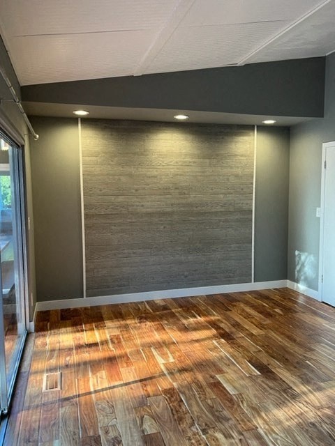 a living room with a wall and a wooden floor