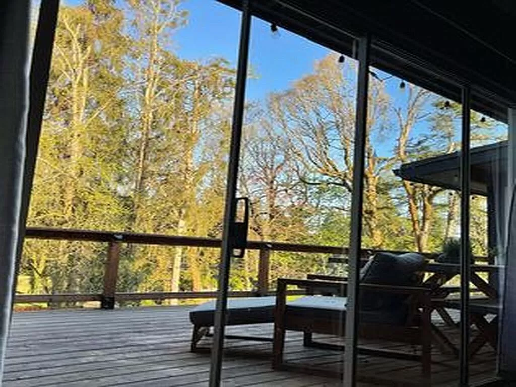 a room with a couch and a chair on a porch