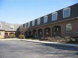 a large brick building with windows and a street