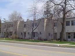 Apartment building on a street corner with a yellow line.