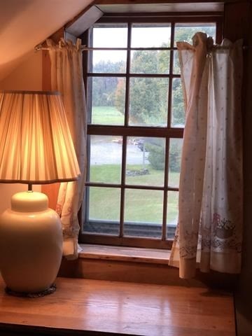 a room with a lamp and a window