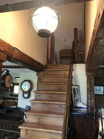 a staircase with wooden steps next to a lamp