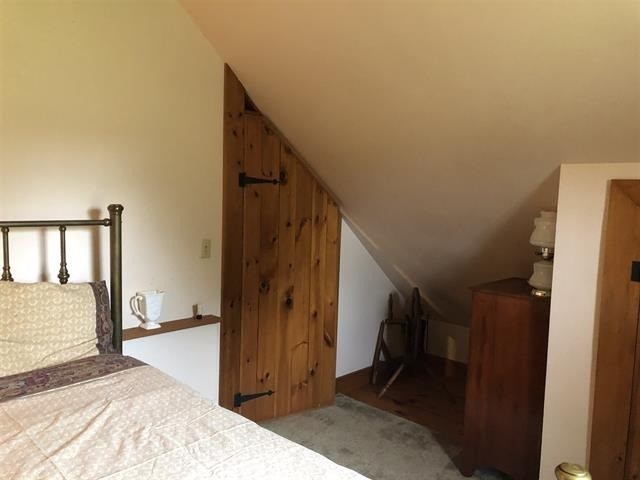 a bedroom with a bed and a wooden door