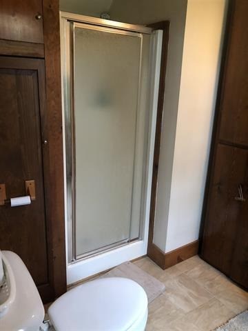 a small bathroom with a shower and a toilet