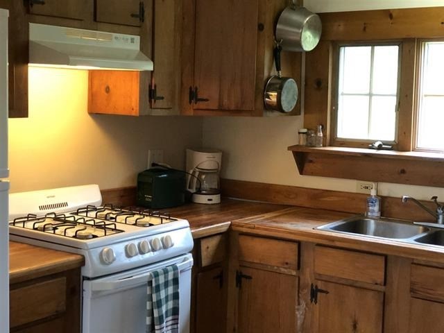 a kitchen with a stove and a sink