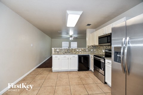 a kitchen with stainless steel appliances and white cabinets