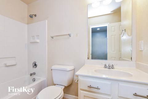a bathroom with a sink toilet and a mirror