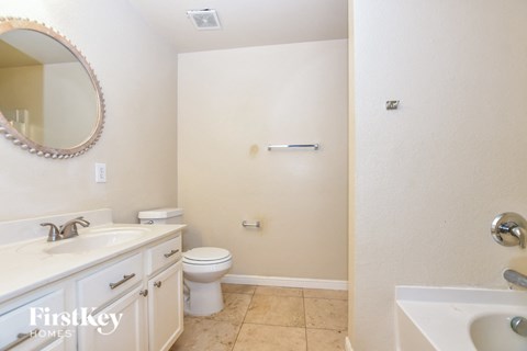 a bathroom with a toilet and a sink and a mirror