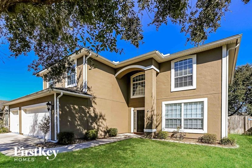 A two-story house with a garage is for sale.