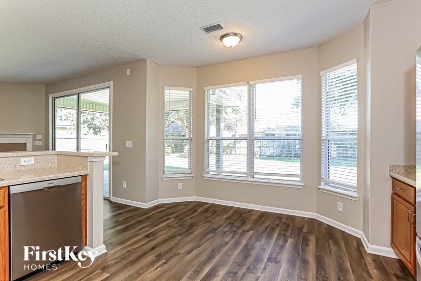 A kitchen with wooden floors and a FirstKey Homes logo.