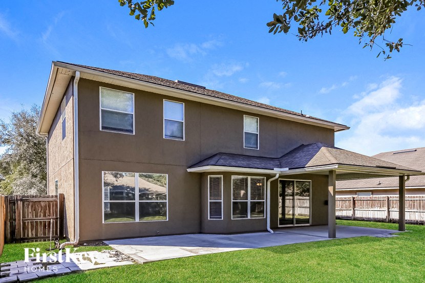 A house with a brown exterior and a covered patio area.