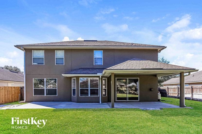 A house with a brown roof and a covered patio area.
